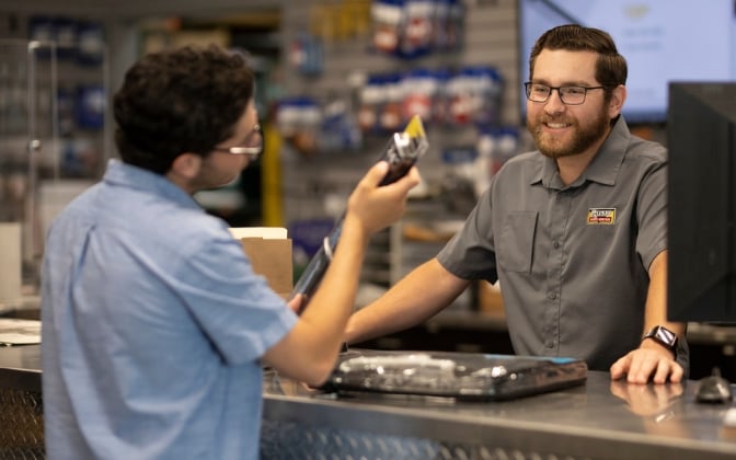 Employee working at part counter helping customer