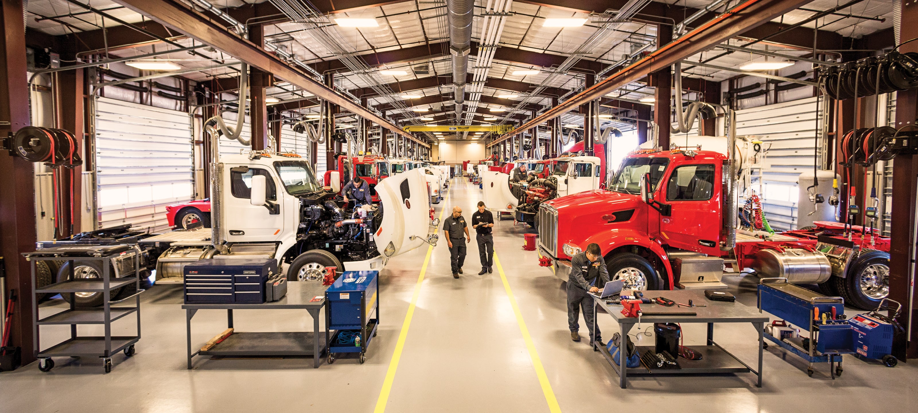 Two technicians walking through Rush Truck Centers service bays