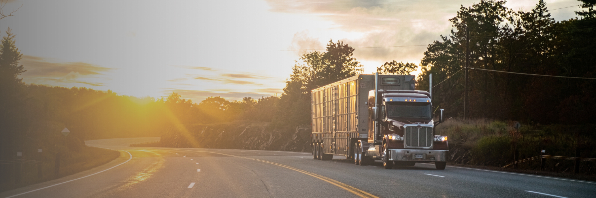 Peterbilt semi truck driving down empty highway