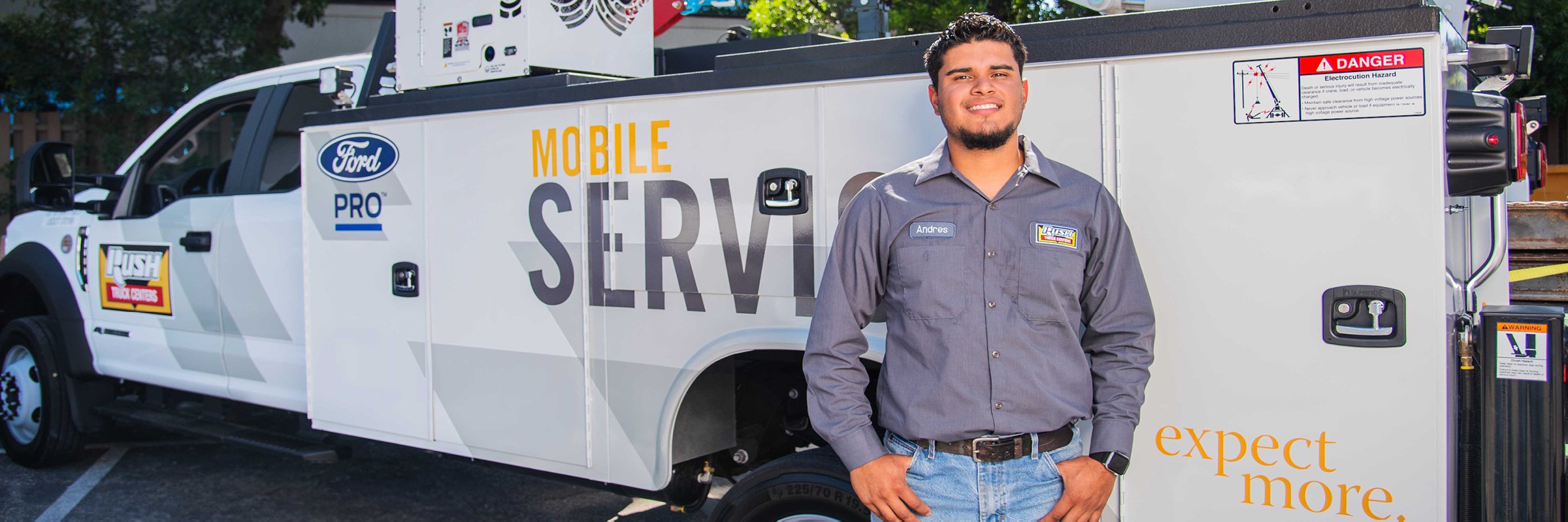 Rush Truck Centers mobile service technician standing in front of mobile service truck